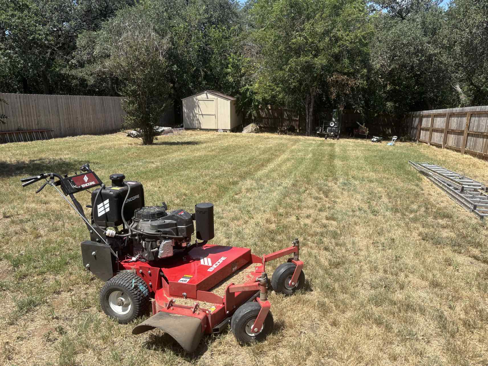 Encore commercial walk-behind mower on residential lawn job site used by Urban Landscaping San Antonio